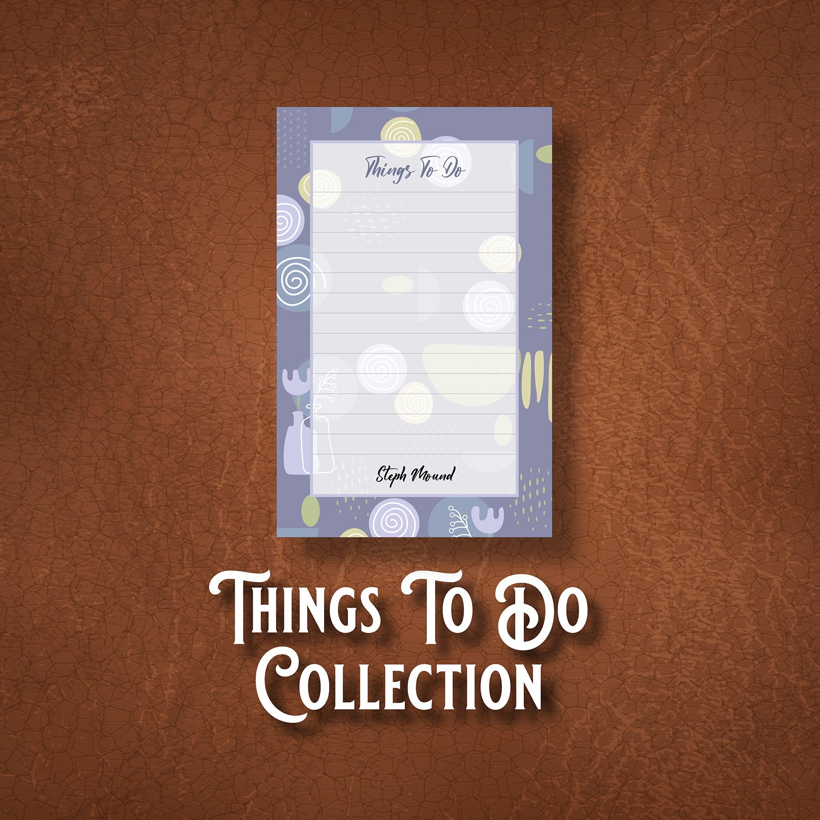 Notepad with lavender background with multi-colored circles placed randomly, all on a brown leather background.